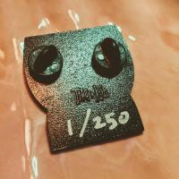 Back of pin showing edition number in white ink.