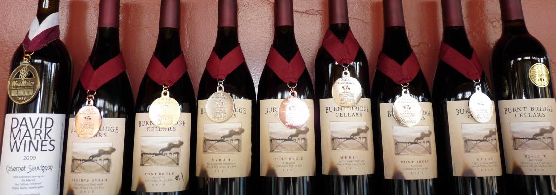 Bottles of Burnt Bridge wine, each wearing a medal.