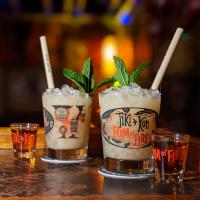 Two Tiki Kon Mai Tai glassware sets shown filled with cocktails and garnished with mint sprigs.